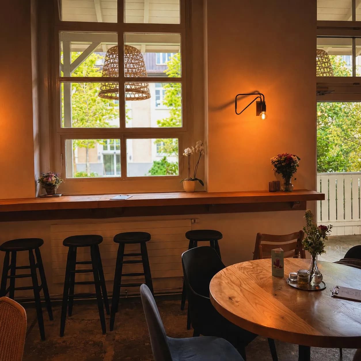 Tische am Fenster im warmen Licht des Kafi Mia